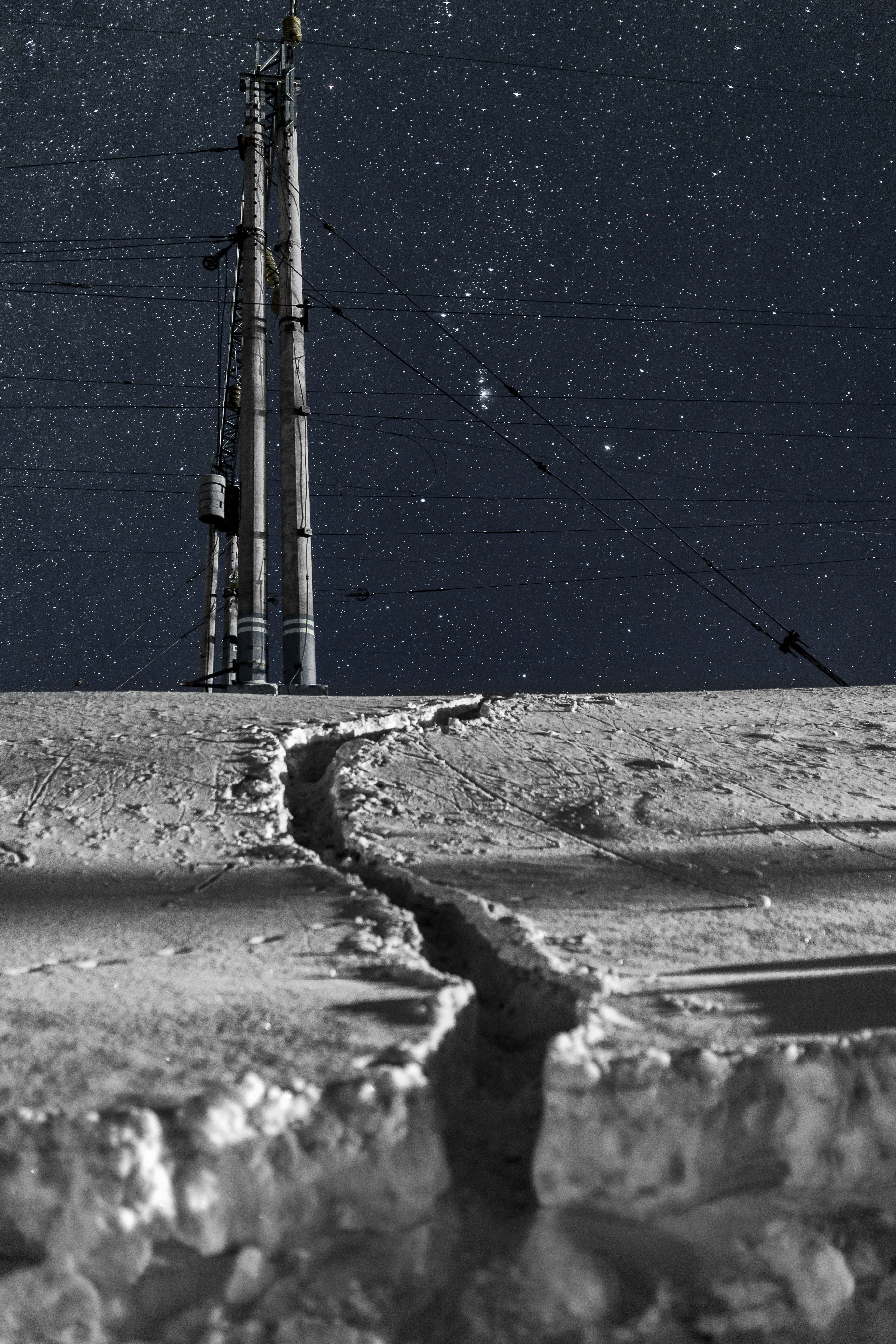 winding paved way on snowfield under starry night sky